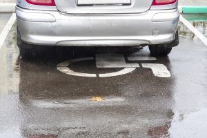 silver car parked on a disabled sign 